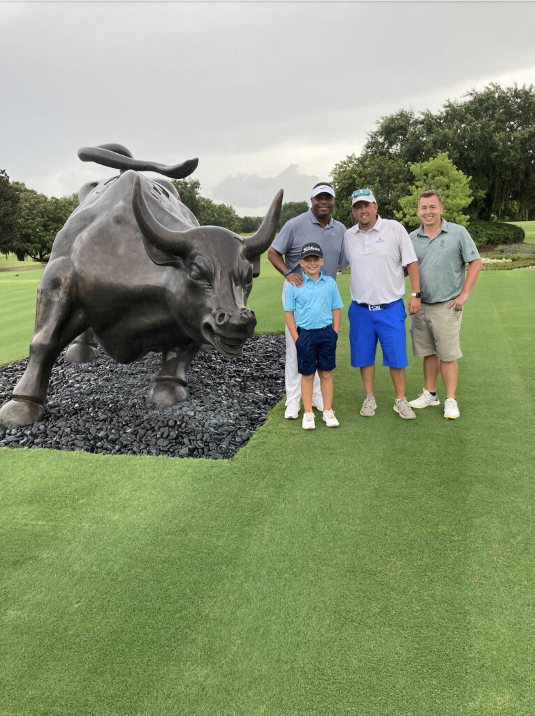 Golf players with bull